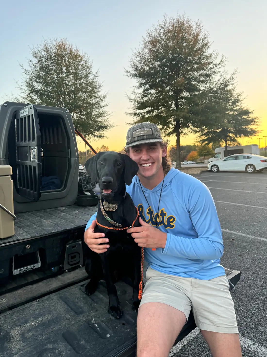 Carter, the owner of Rooster Resin, with his dog